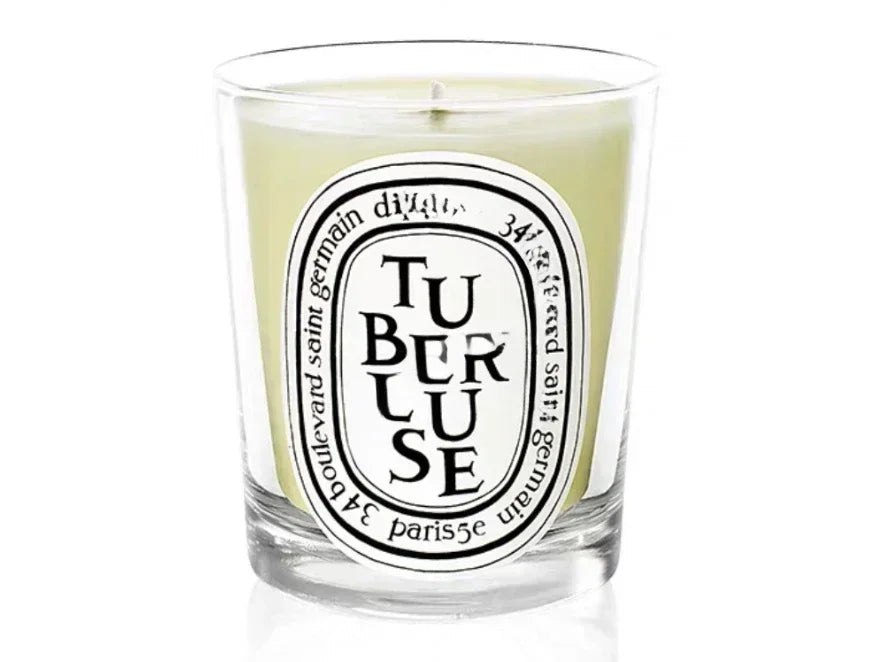 Tubereuse scented candle in a glass jar on white background