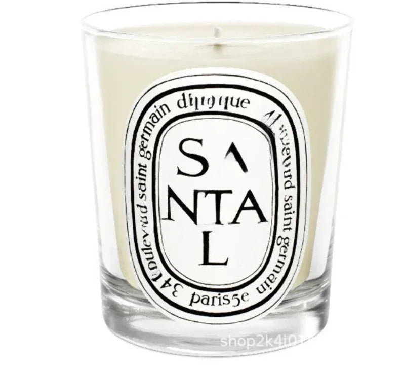 Santal scented candle in a glass jar on white background