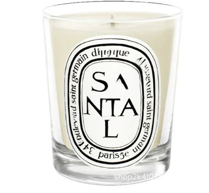 Santal scented candle in a glass jar on white background

