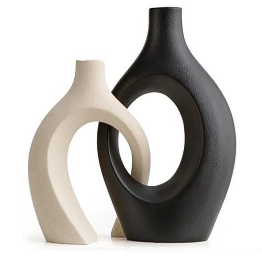 White and black minimalist ceramic vase displayed on a neutral background.